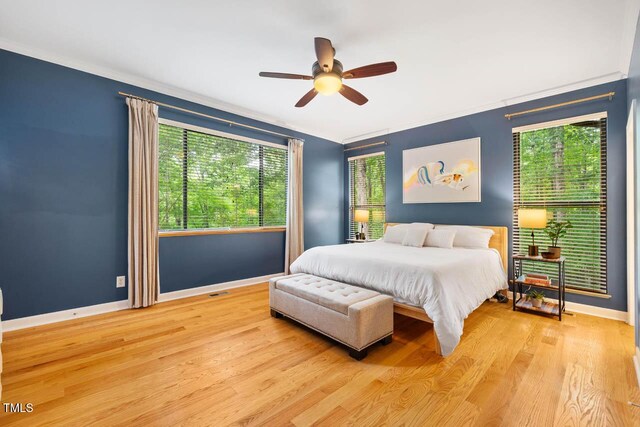 8821 Oconee Ct, Chapel Hill, NC 27516 - bedroom with multiple windows, baseboards, light wood-style floors, and ornamental molding