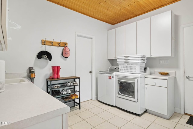 8821 Oconee Ct, Chapel Hill, NC 27516 - laundry area with cabinet space, wood ceiling, washing machine and clothes dryer, and light tile patterned floors
