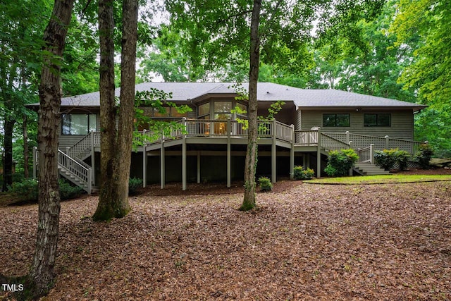 8821 Oconee Ct, Chapel Hill, NC 27516 - rear view of house featuring stairs, a deck, and roof with shingles