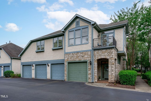 201 Presque Isle Ln, Chapel Hill, NC 27514 - view of front facade with a balcony, stone siding, a garage, and asphalt driveway