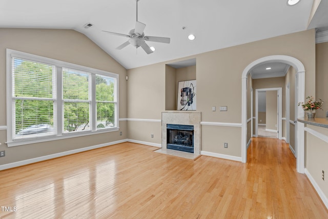 201 Presque Isle Ln, Chapel Hill, NC 27514 - unfurnished living room with a ceiling fan, arched walkways, light wood-style flooring, a tiled fireplace, and vaulted ceiling