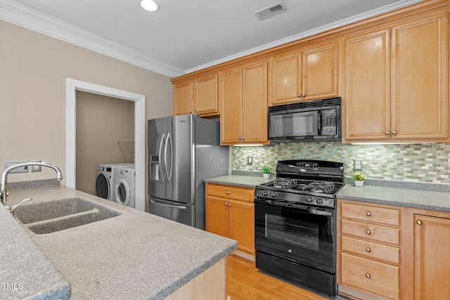 201 Presque Isle Ln, Chapel Hill, NC 27514 - kitchen featuring black appliances, a sink, washing machine and clothes dryer, ornamental molding, and backsplash