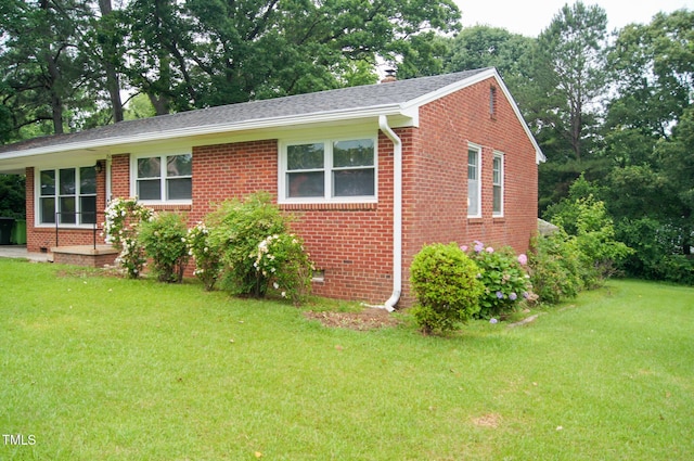 2626 Crestline Ave, Raleigh, NC 27603 - view of front of house with brick siding, a front lawn, and a chimney