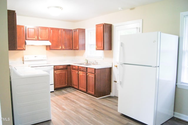 2626 Crestline Ave, Raleigh, NC 27603 - kitchen featuring white appliances, a sink, under cabinet range hood, light wood-style floors, and light countertops