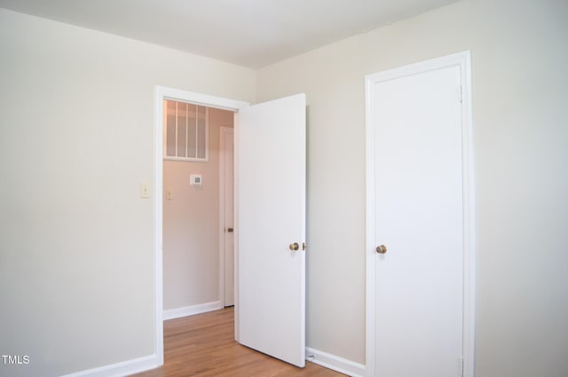 2626 Crestline Ave, Raleigh, NC 27603 - unfurnished bedroom featuring light wood finished floors and baseboards