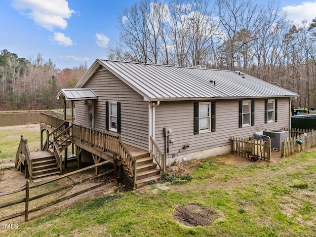 501 Enon Rd, Oxford, NC 27565 - rear view of property featuring a wooden deck, stairway, metal roof, and central AC unit