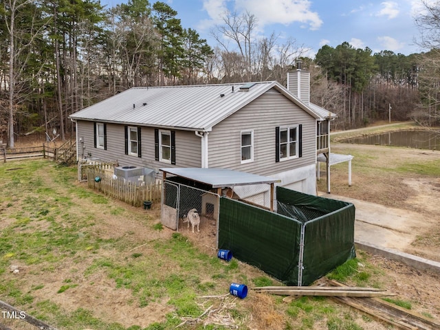 501 Enon Rd, Oxford, NC 27565 - back of property with a chimney, metal roof, an outbuilding, exterior structure, and an attached garage