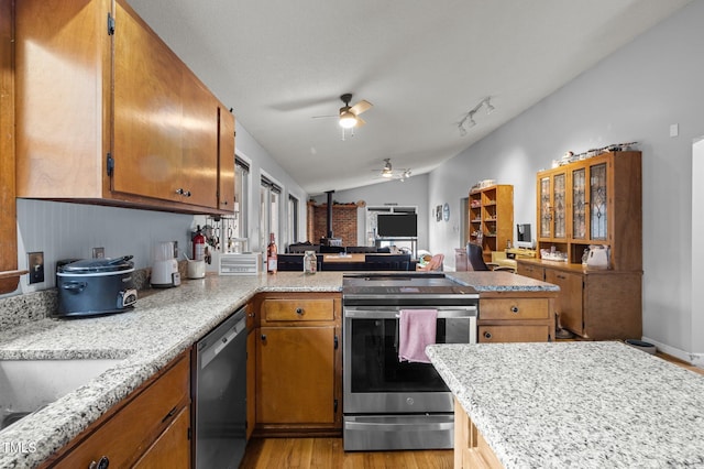 501 Enon Rd, Oxford, NC 27565 - kitchen with stainless steel appliances, vaulted ceiling, a peninsula, a ceiling fan, and light wood finished floors