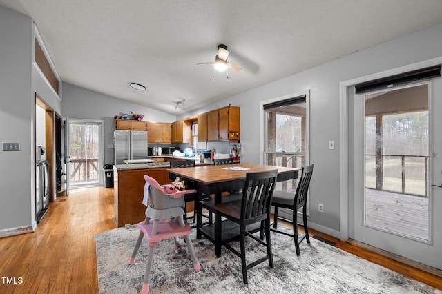 501 Enon Rd, Oxford, NC 27565 - dining area featuring ceiling fan, light wood-style flooring, lofted ceiling, a textured ceiling, and baseboards