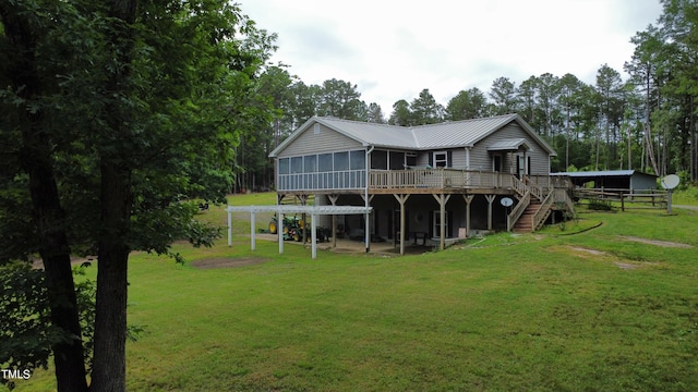 501 Enon Rd, Oxford, NC 27565 - back of house with a sunroom, stairs, a wooden deck, a yard, and metal roof