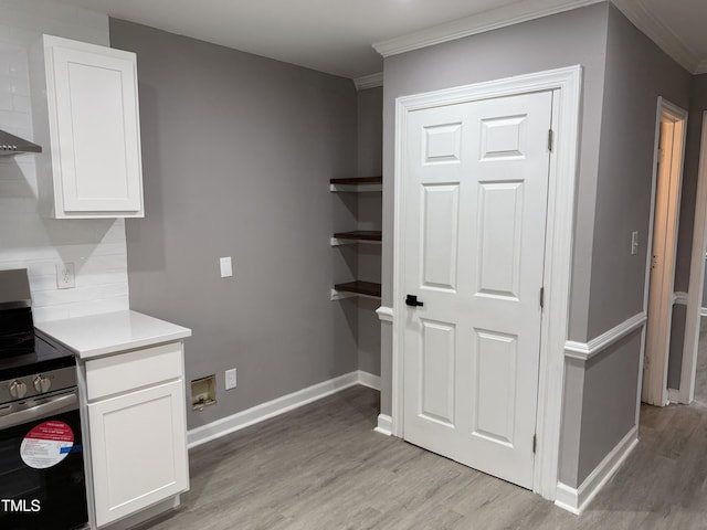 3825 Old Coach Rd, Raleigh, NC 27616 - kitchen with stainless steel electric range, light wood-style flooring, ornamental molding, white cabinetry, and baseboards