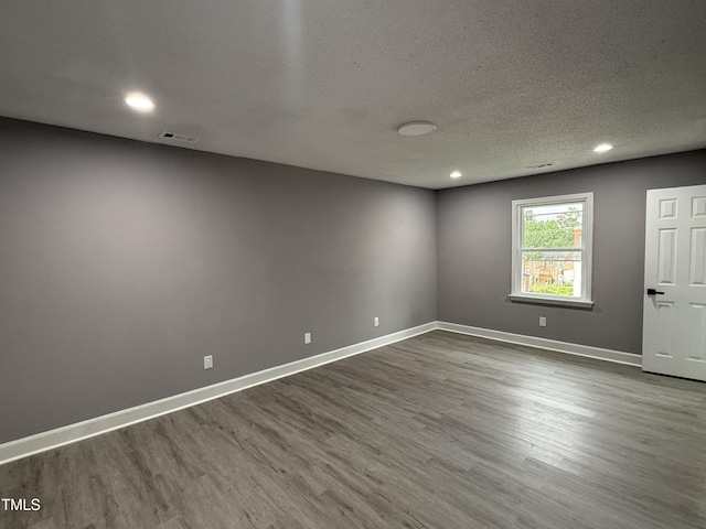 3825 Old Coach Rd, Raleigh, NC 27616 - unfurnished room with dark wood-style floors, recessed lighting, baseboards, and a textured ceiling