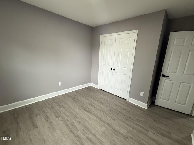 3825 Old Coach Rd, Raleigh, NC 27616 - unfurnished bedroom with wood finished floors, baseboards, and a closet