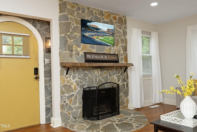 106 E Club Blvd, Durham, NC 27704 - living area with a stone fireplace, plenty of natural light, wood finished floors, and baseboards