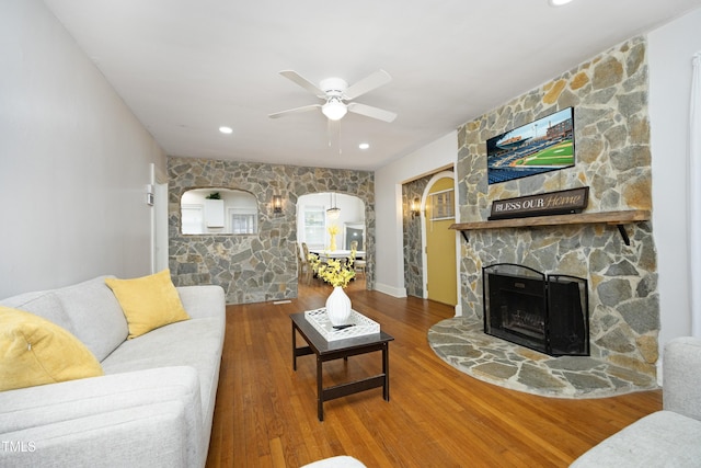 106 E Club Blvd, Durham, NC 27704 - living area with a ceiling fan, wood finished floors, a stone fireplace, recessed lighting, and arched walkways