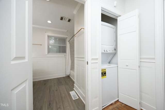 106 E Club Blvd, Durham, NC 27704 - laundry room featuring stacked washing machine and dryer, ornamental molding, wood finished floors, wainscoting, and a decorative wall