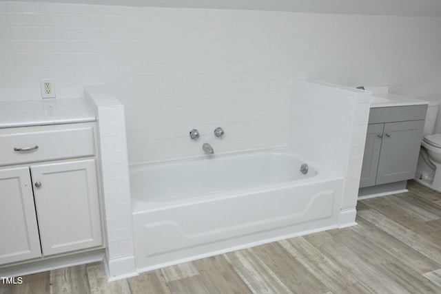106 E Club Blvd, Durham, NC 27704 - full bathroom featuring vanity, a bath, wood finished floors, and toilet