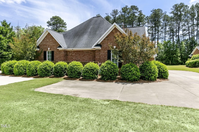 3628 Eagle Farm Dr N, Wilson, NC 27896 - view of front of home featuring brick siding, a front yard, and a shingled roof