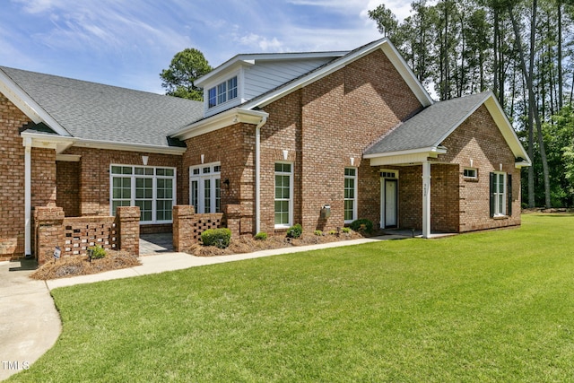 3628 Eagle Farm Dr N, Wilson, NC 27896 - view of front of home featuring a front lawn, brick siding, and roof with shingles