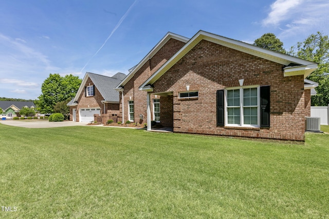 3628 Eagle Farm Dr N, Wilson, NC 27896 - view of front of house with brick siding, central AC unit, a front yard, and a garage