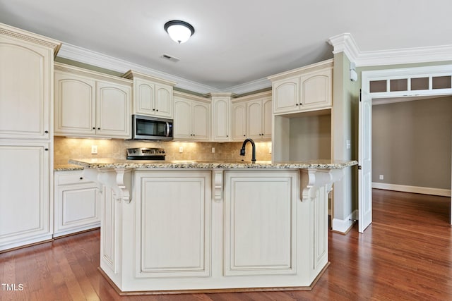 3628 Eagle Farm Dr N, Wilson, NC 27896 - kitchen with cream cabinetry, appliances with stainless steel finishes, backsplash, and dark wood-style flooring
