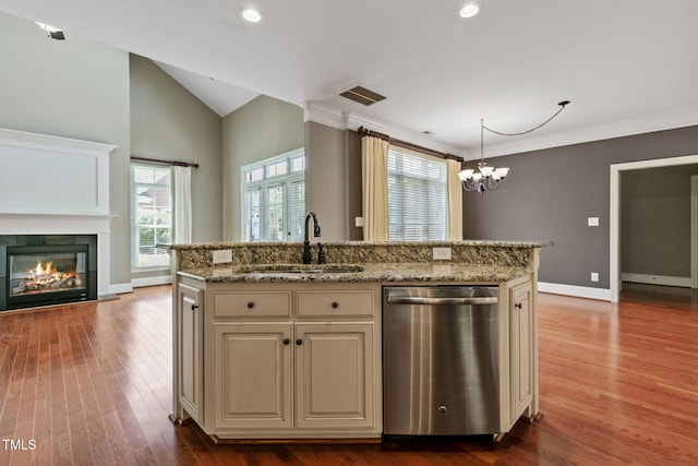 3628 Eagle Farm Dr N, Wilson, NC 27896 - kitchen with stainless steel dishwasher, a sink, cream cabinetry, wood finished floors, and open floor plan