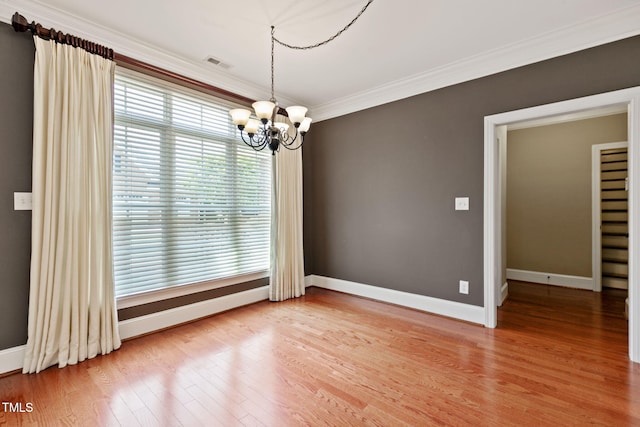 3628 Eagle Farm Dr N, Wilson, NC 27896 - empty room with a chandelier, baseboards, crown molding, and light wood-style floors