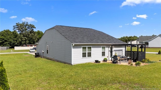 308 Hazel Dr, Stantonsburg, NC 27883 - back of property with a yard, a patio area, and a shingled roof