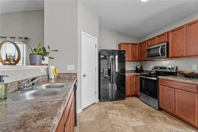 308 Hazel Dr, Stantonsburg, NC 27883 - kitchen featuring appliances with stainless steel finishes, a sink, lofted ceiling, and brown cabinets