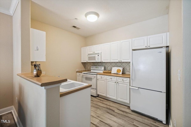 1912 Parkside Village Dr, Clayton, NC 27520 - kitchen featuring white appliances, white cabinets, light wood finished floors, and decorative backsplash