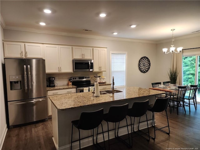 207 Southwick Ct, Sanford, NC 27332 - kitchen featuring stainless steel appliances, dark wood-type flooring, light stone countertops, white cabinetry, and a sink