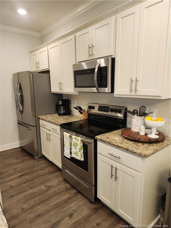 207 Southwick Ct, Sanford, NC 27332 - kitchen with appliances with stainless steel finishes, ornamental molding, dark wood-style floors, white cabinets, and light stone counters