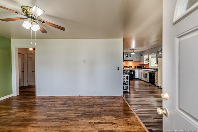 2327 Dewitt St, Sanford, NC 27330 - unfurnished living room featuring ceiling fan, dark wood finished floors, a sink, and baseboards