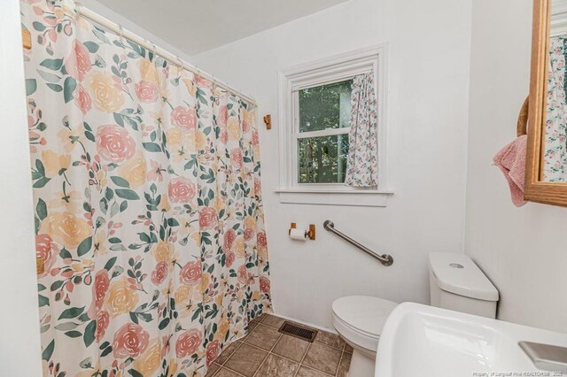 2327 Dewitt St, Sanford, NC 27330 - bathroom with toilet, a shower with shower curtain, and tile patterned flooring