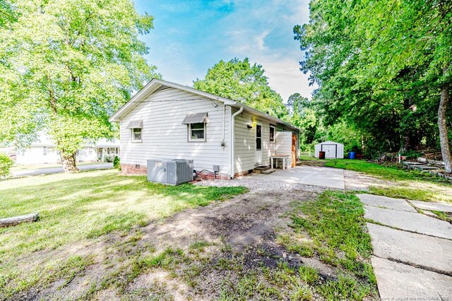 2327 Dewitt St, Sanford, NC 27330 - view of home's exterior featuring central air condition unit, a lawn, and crawl space