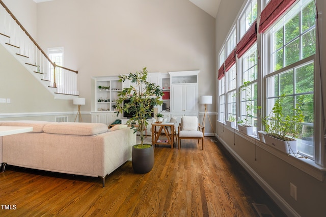 116 Hamilton Hedge Pl, Cary, NC 27519 - living room featuring high vaulted ceiling, wood finished floors, baseboards, and stairway