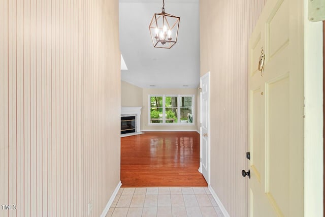 1014 Laurens Way, Knightdale, NC 27545 - hall with light tile patterned floors, a chandelier, vaulted ceiling, and baseboards