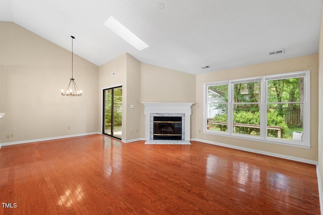 1014 Laurens Way, Knightdale, NC 27545 - unfurnished living room with light wood-type flooring, healthy amount of natural light, a high end fireplace, a chandelier, and high vaulted ceiling