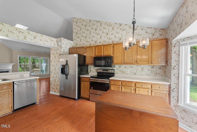 1014 Laurens Way, Knightdale, NC 27545 - kitchen with stainless steel appliances, wallpapered walls, lofted ceiling, light wood-style flooring, and a chandelier