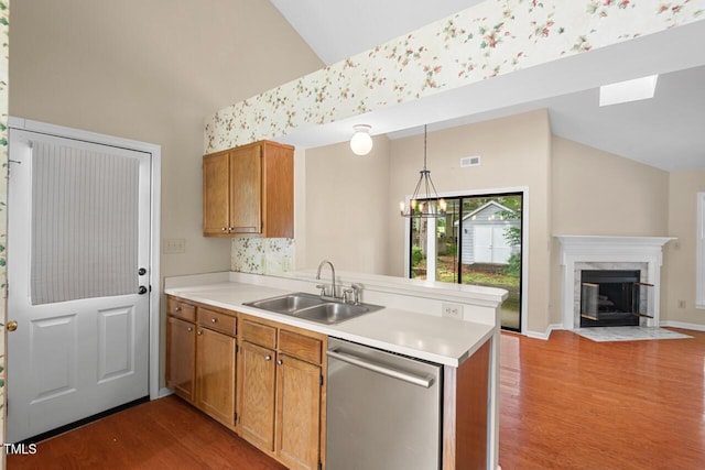 1014 Laurens Way, Knightdale, NC 27545 - kitchen with stainless steel dishwasher, a sink, a peninsula, high vaulted ceiling, and open floor plan