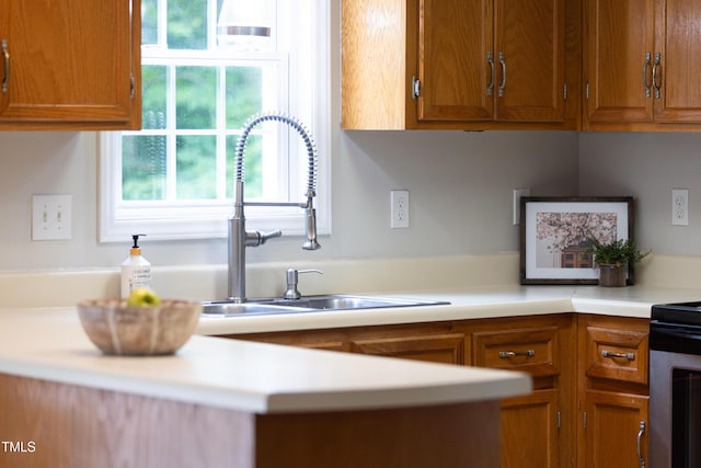 657 Lakeview Dr, Stem, NC 27581 - kitchen featuring a sink, brown cabinets, light countertops, and stove
