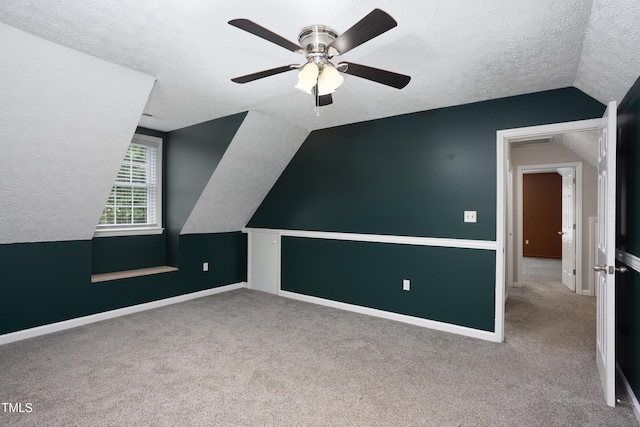 657 Lakeview Dr, Stem, NC 27581 - additional living space with lofted ceiling, a textured ceiling, carpet floors, a ceiling fan, and baseboards