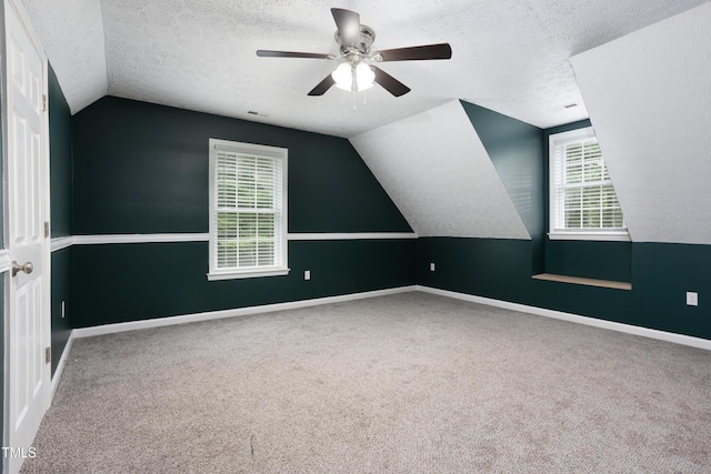 657 Lakeview Dr, Stem, NC 27581 - bonus room featuring a textured ceiling, vaulted ceiling, ceiling fan, carpet floors, and baseboards