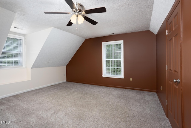 657 Lakeview Dr, Stem, NC 27581 - additional living space featuring a textured ceiling, carpet, baseboards, vaulted ceiling, and ceiling fan