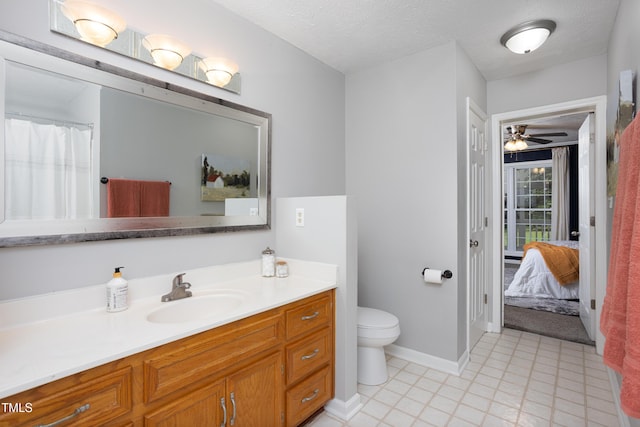 657 Lakeview Dr, Stem, NC 27581 - ensuite bathroom featuring toilet, vanity, baseboards, and ceiling fan