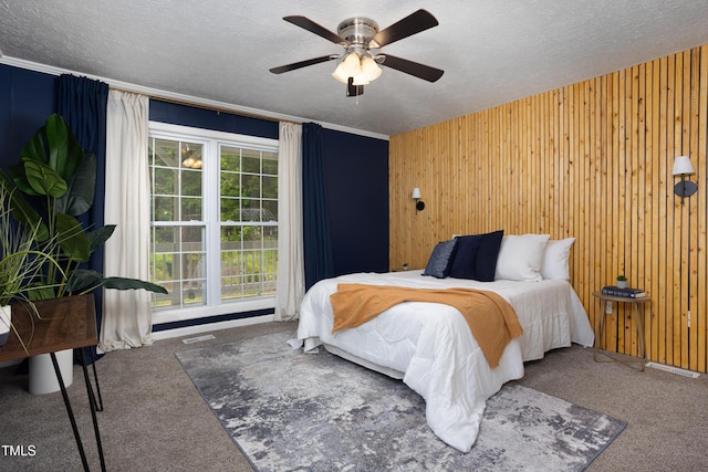 657 Lakeview Dr, Stem, NC 27581 - carpeted bedroom featuring a textured ceiling, wooden walls, and a ceiling fan