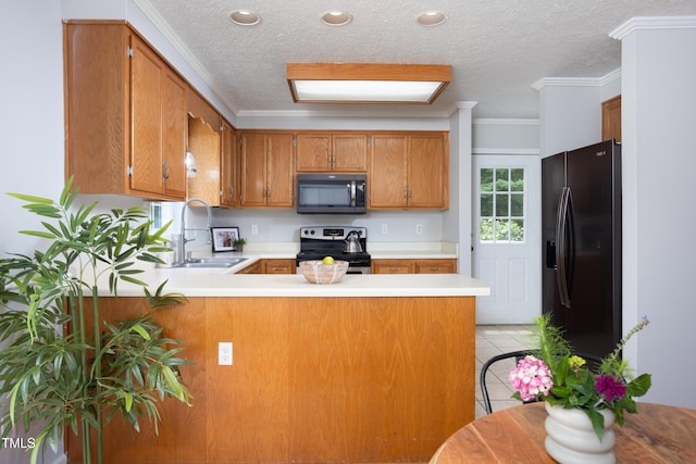 657 Lakeview Dr, Stem, NC 27581 - kitchen featuring black appliances, a sink, a peninsula, brown cabinetry, and light countertops
