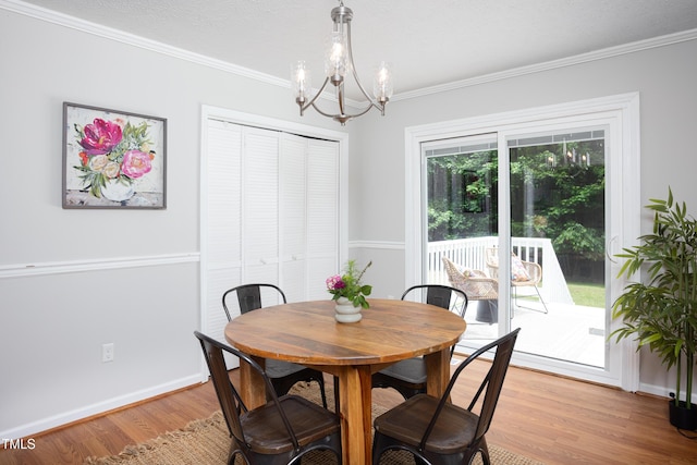 657 Lakeview Dr, Stem, NC 27581 - dining area with a chandelier, light wood-type flooring, crown molding, and baseboards