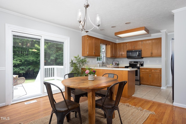 657 Lakeview Dr, Stem, NC 27581 - dining area featuring plenty of natural light, crown molding, a chandelier, and light wood-style flooring
