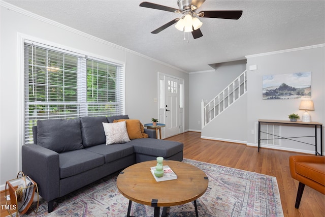 657 Lakeview Dr, Stem, NC 27581 - living room featuring wood finished floors, a textured ceiling, a ceiling fan, crown molding, and stairway